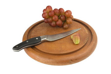 grapes red slice with knife on wood chopping board