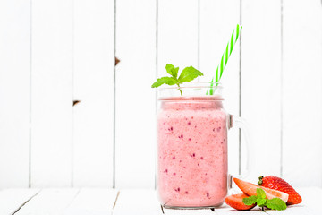 Fruit smoothie with strawberries, milkshake with strawberry blended in jar on white background. Vegan diet and healthy lifestyle concept. - obrazy, fototapety, plakaty