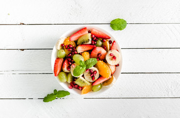 Fresh fruit salad, healthy diet, vegan food on table, overhead