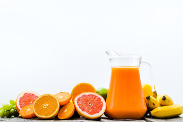 Healthy juice with fruits. Freshly squeezed fruits, vitamin drink, refreshing summer beverage in pitcher.