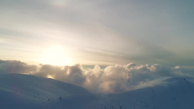 Winterland, fly over mountains in evening sunlight