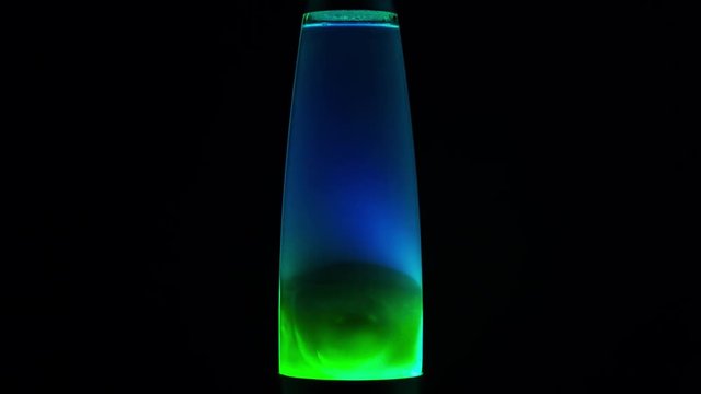 Time-lapse video of lava lamp starting with its heating, on a black background closeup
