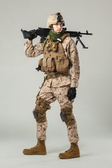 Soldier in camouflage holding rifle