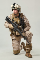 Soldier in camouflage holding rifle