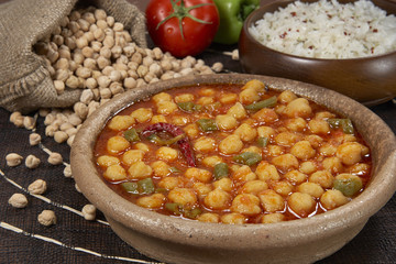 chickpeas in tomato sauce in bowl closeup. horizontal
