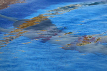 the girl is floating under the water