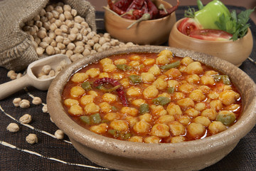 chickpeas in tomato sauce in bowl closeup. horizontal
