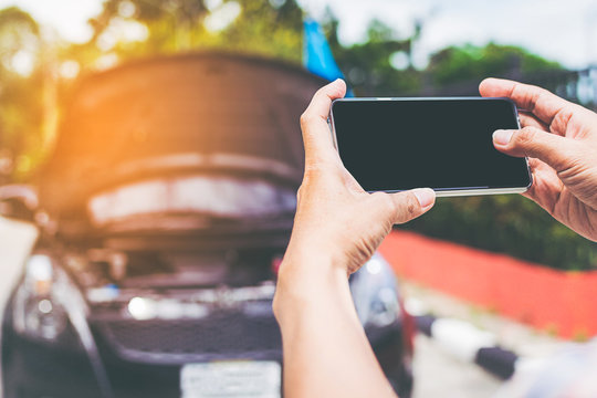 Closeup shot of man using smartphone with isolated screen after car accident