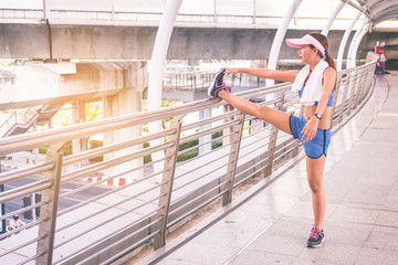 Woman is exercising in the city