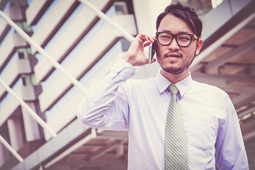 businessman in suit using smartphone at city