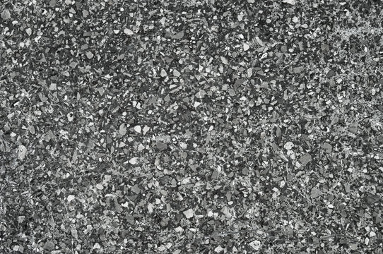 Texture of small gravel stone in a concrete slab cement floor close-up