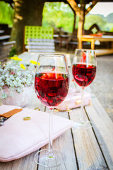 A glass and a bottle of rose in the autumn vineyard. Harvest time, summer time in the garden on the terrace