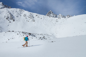 A skier walks in the mountains