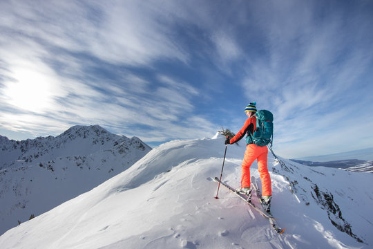 A skier walks in the mountains