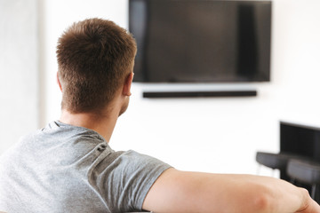 Back view of young man sitting
