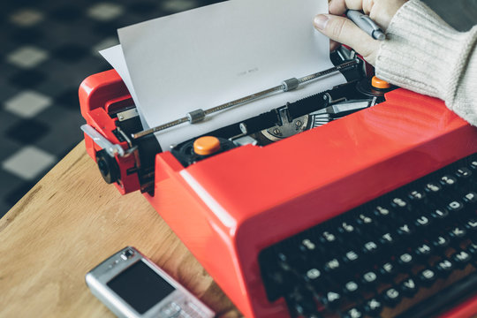 Cell phone and hand using typewriter