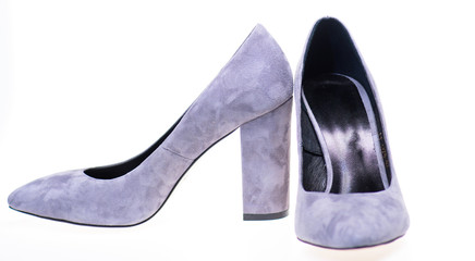 Shoes made out of grey suede on white background, isolated. Pair of fashionable high heeled shoes. Female footwear concept. Footwear for women with thick high heels.