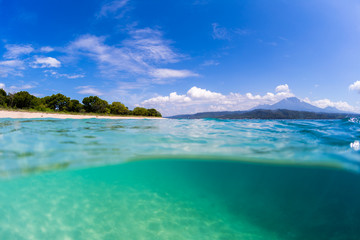 Tropical beach on Bali. Split shot with underwater view of the tropical beach located on the island of Bali, Indonesia