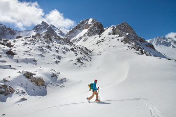 Naklejka na ściany i meble A skier walks in the mountains