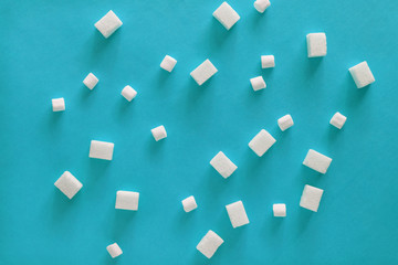Sugar cubes and marshmallows on blue background