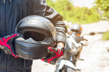 Man in a Motorcycle with helmet and gloves is an important protective clothing for motorcycling...