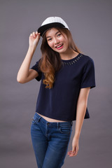 Fototapeta premium happy asian girl with smiling woman face; portrait of happy, smiling, joyful, cheerful asian woman in casual dress studio isolated; asian chinese young adult woman model
