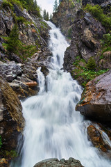 Naklejka na ściany i meble Waterfall in the mountains