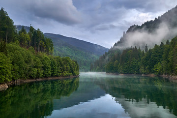Lake in the mountains on a foggy day