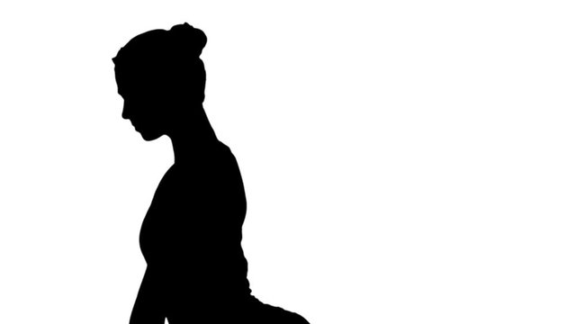 Side view portrait of beautiful young woman doing yoga or pilates exercise. One Legged King Pigeon pose, Eka Pada Rajakapotasana track matte