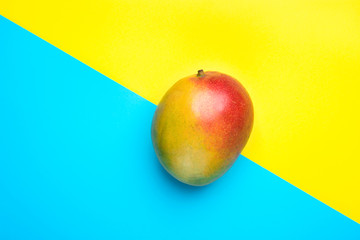Ripe Red Green Mango on Split Duotone Yellow Blue Diagonal Background. Styled Creative Image....