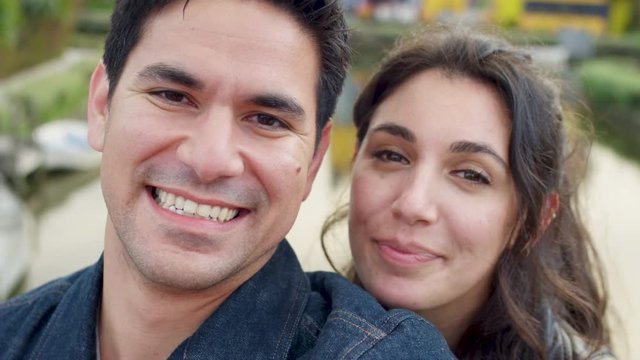 Cute Couple Pose For Portrait, They Smile Then Make Silly Faces At Venice Beach Canals, CA (Slow Motion)