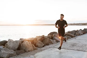 Foto op Canvas Portrait of a healthy sportsman jogging © Drobot Dean