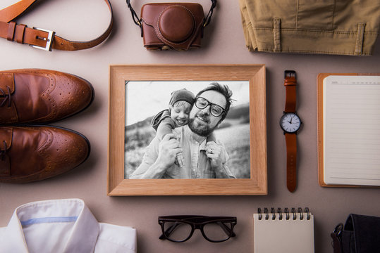 Fathers day greeting card concept. A photo of a dad and toddler son. Flat lay.