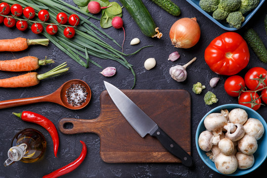 Photo on top of fresh vegetables, champignons, cutting board, oil, knife
