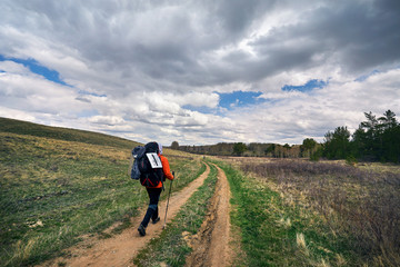Fototapeta premium Tourist with backpack on the road