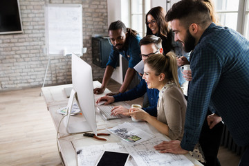 Young architects working on project in office