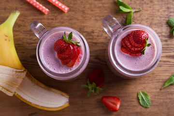 Milkshake with strawberries and banana. Strawberry smoothie. View from above, top studio shot