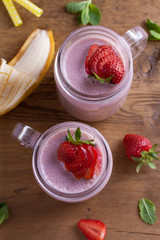 Milkshake with strawberries and banana. Strawberry smoothie. View from above, top studio shot