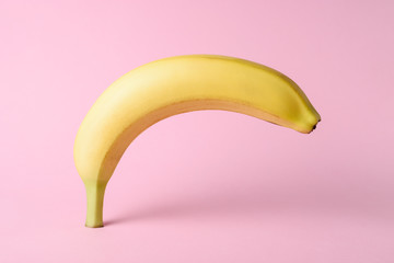 Banana on pink background. Minimal style. Flat lay. Food concept.
