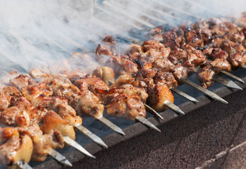 Juicy slices of meat with sauce prepare on fire