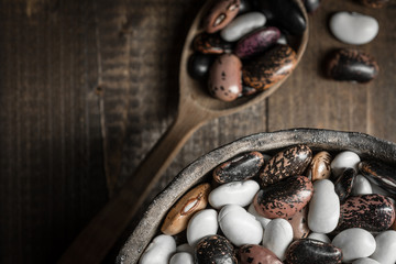 Raw Colorful Beans on Dark Wooden Background