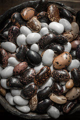 Raw Colorful Beans on Dark Wooden Background
