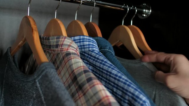 Closeup - Male chooses clothes for a business meeting. Shopping concept.