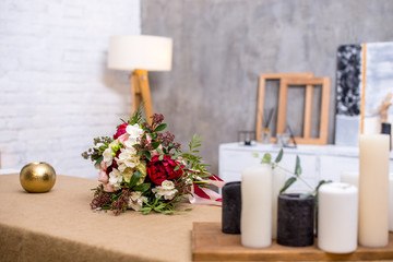 Fototapeta na wymiar beautiful modern wedding bouquet on the table. Against the gray wall