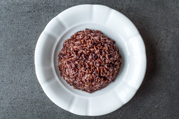 Cooked Black Rice in white Plate with Chopsticks.