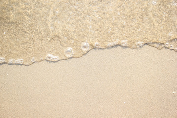 Fototapeta na wymiar Soft clear sea wave on the beach sand background.