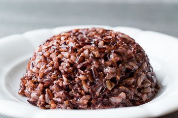 Cooked Black Rice in white Plate with Chopsticks.