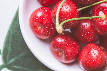 Fresh Ripe Cherries in White Bowl with Copy Space. Summer and Harvest Concept.