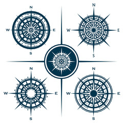 Vector set of blue isolated compass roses. Collection of different wind roses for graphic design. Vector illustration.