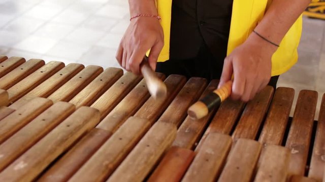 Asian Indonesian Balinese musician gamelan instrument. Closeup hands playing. Not edited, raw file.